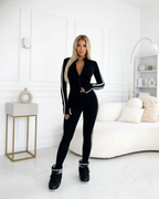 Mono deportivo ajustado con cremallera y bandas laterales para mujer