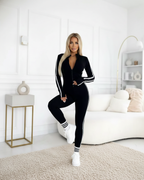 Mono deportivo ajustado con cremallera y bandas laterales para mujer