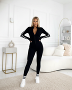 Mono deportivo ajustado con cremallera y bandas laterales para mujer